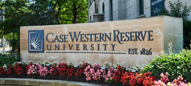 Case Western Reserve University sign surrounded by flowers