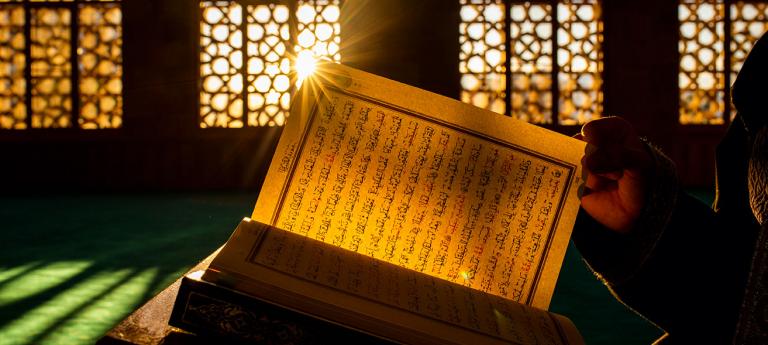 A Quran in a mosque at sunset