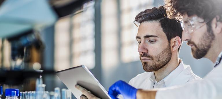Two scientist using digital tablet in laboratory