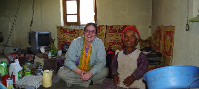 A woman sitting next to a man with dwarfism