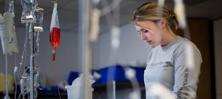 A woman working on a prosthetic 