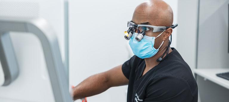 A Case Western Reserve University dental student wearing dental goggles at work