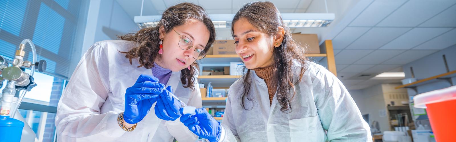Two biomedical engineering students working together in a lab