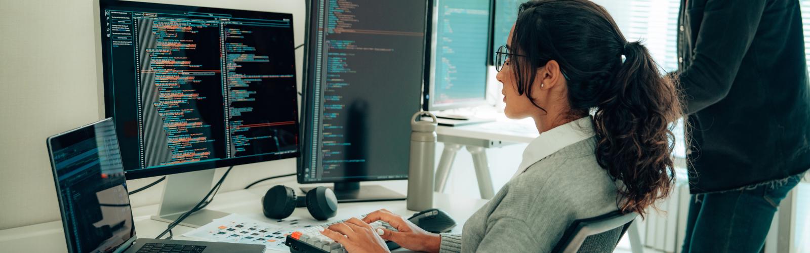 Computer scientist working on code on a computer