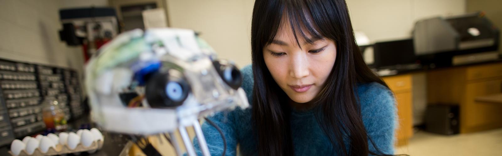 A mechanical engineering student with a robot