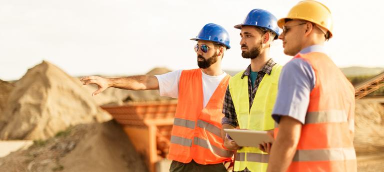 Three civil engineers on a work site.