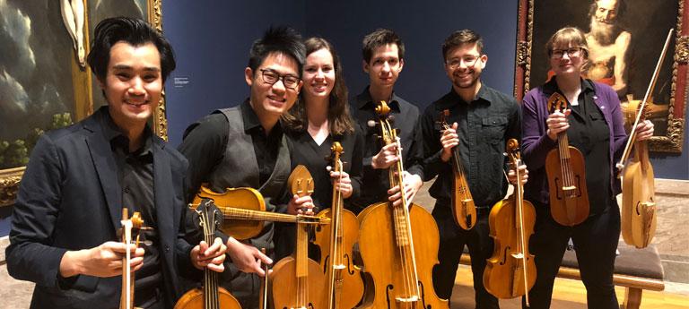 A group of Case Western Reserve University students posing with string instruments