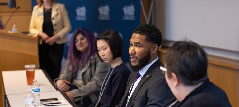 A group of students speaking at an open house event