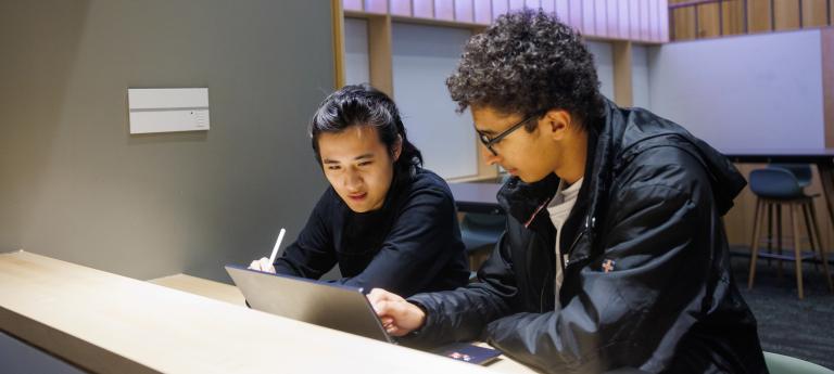Two engineering students working on computers