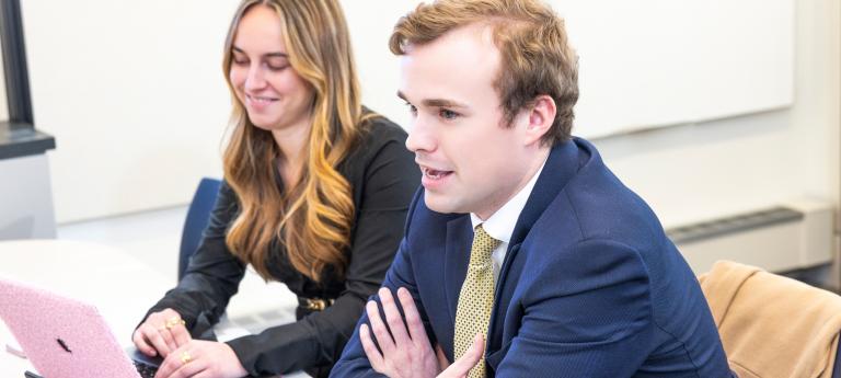 Two law students sitting at a computer