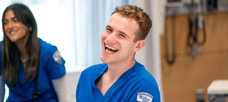 A nursing student laughing