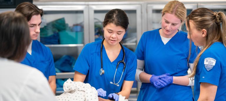Four nursing students in scrubs