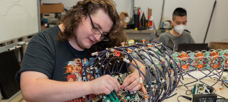 A mechanical engineering student assembling a robot