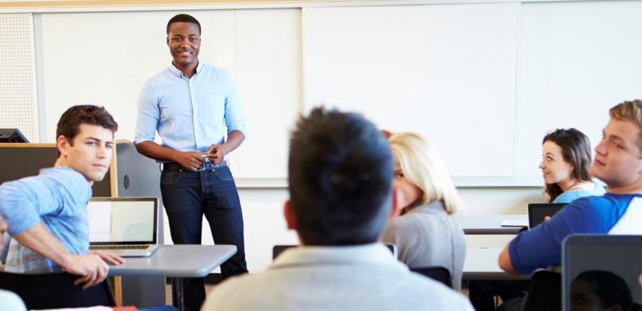 A man standing in front of classroom.