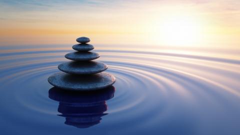 Stones stacked in a pool of water.