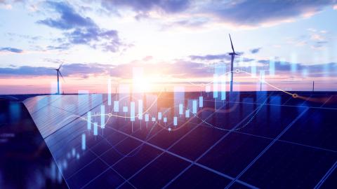 A graph superimposed over windmills and solar panels