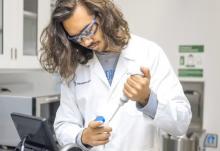 A student in a lab coat.