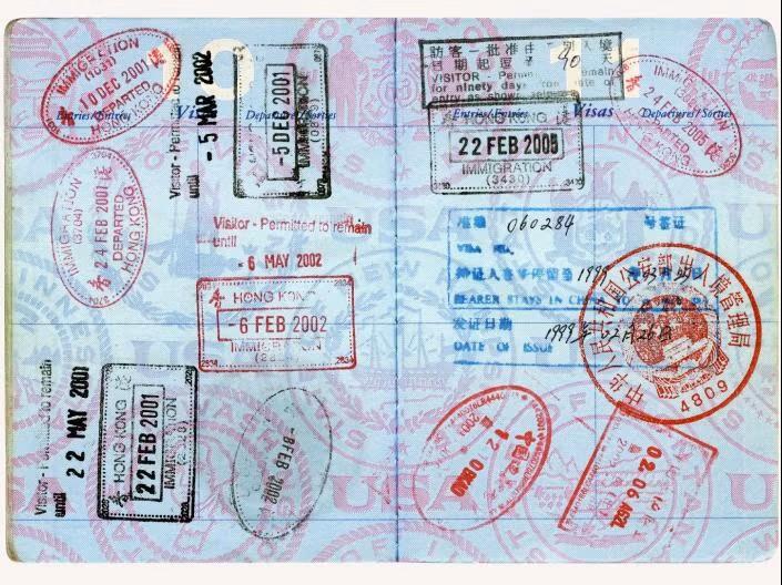 A passport opened to reveal many stamps