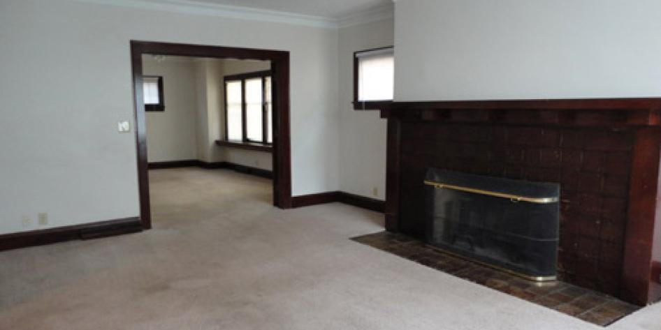 White living room with fireplace and beige carpet