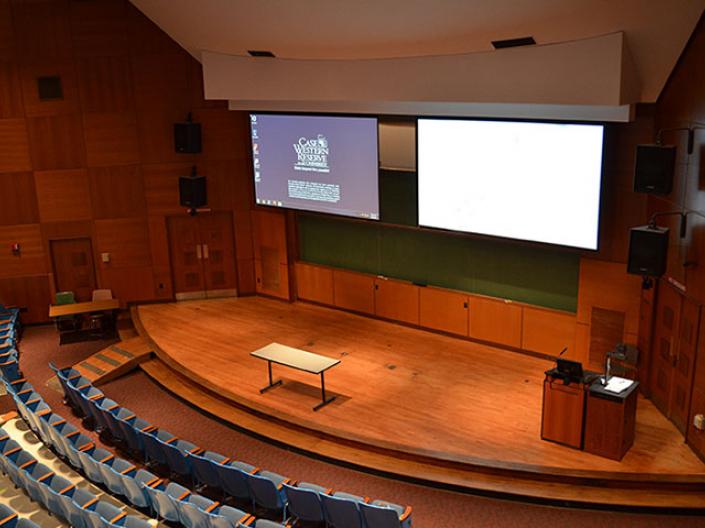 The inside of one of CWRU's rooms with a screen and presentation
