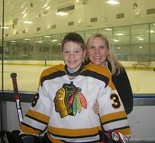 Case Western Reserve University staff member Tracy Wilson-Holden and her son at a hockey game