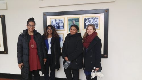 Four female Case Western Reserve students posed in a hallway