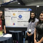 Three female Case Western Reserve students posed beside their research project poster
