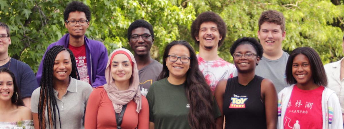 Photograph of students from the Emerging Scholars Program, a diverse group of young people smiling at the camera
