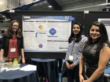 Three female Case Western Reserve students posed beside their research project poster