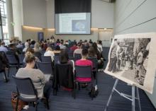 People gathered and seated in a lecture room for a presentation