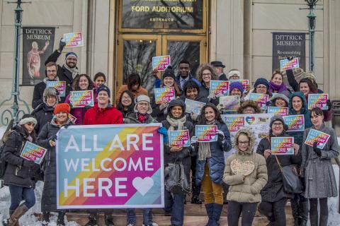 Photograph of students, staff and faculty of CWRU with "You are welcome here" banners