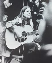 Photograph of woman playing guitar from CWRU yearbook