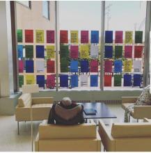 Photograph of chatterboard, colorful papers with statements about gender-based violence
