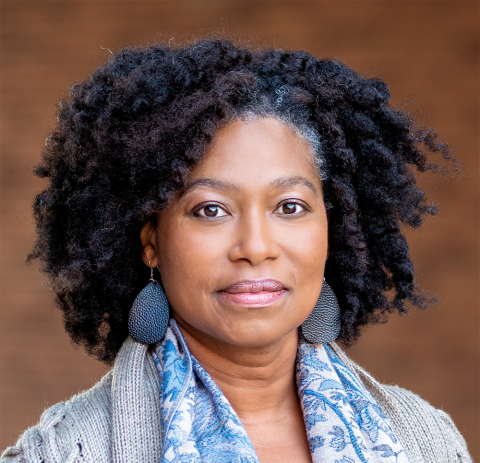 Lynette Hammond Gerido profile picture, black hair with blue dangling earrings, and a blue scarf around her neck