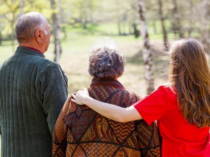 Three people walking away from the camera