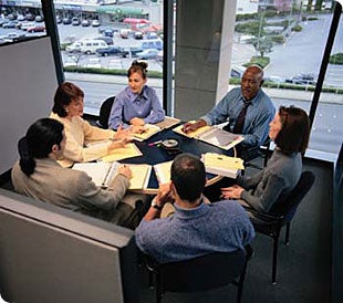 group of professionals sitting around a table