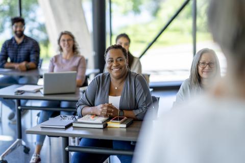 People sitting at tables in classroom setting