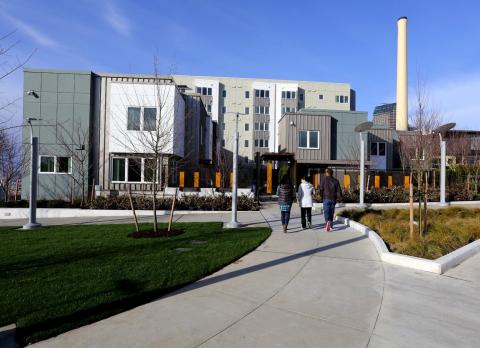 Three people entering building