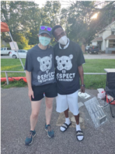 two people wearing masks and t-shirts with the slogan Respect the Groundhog