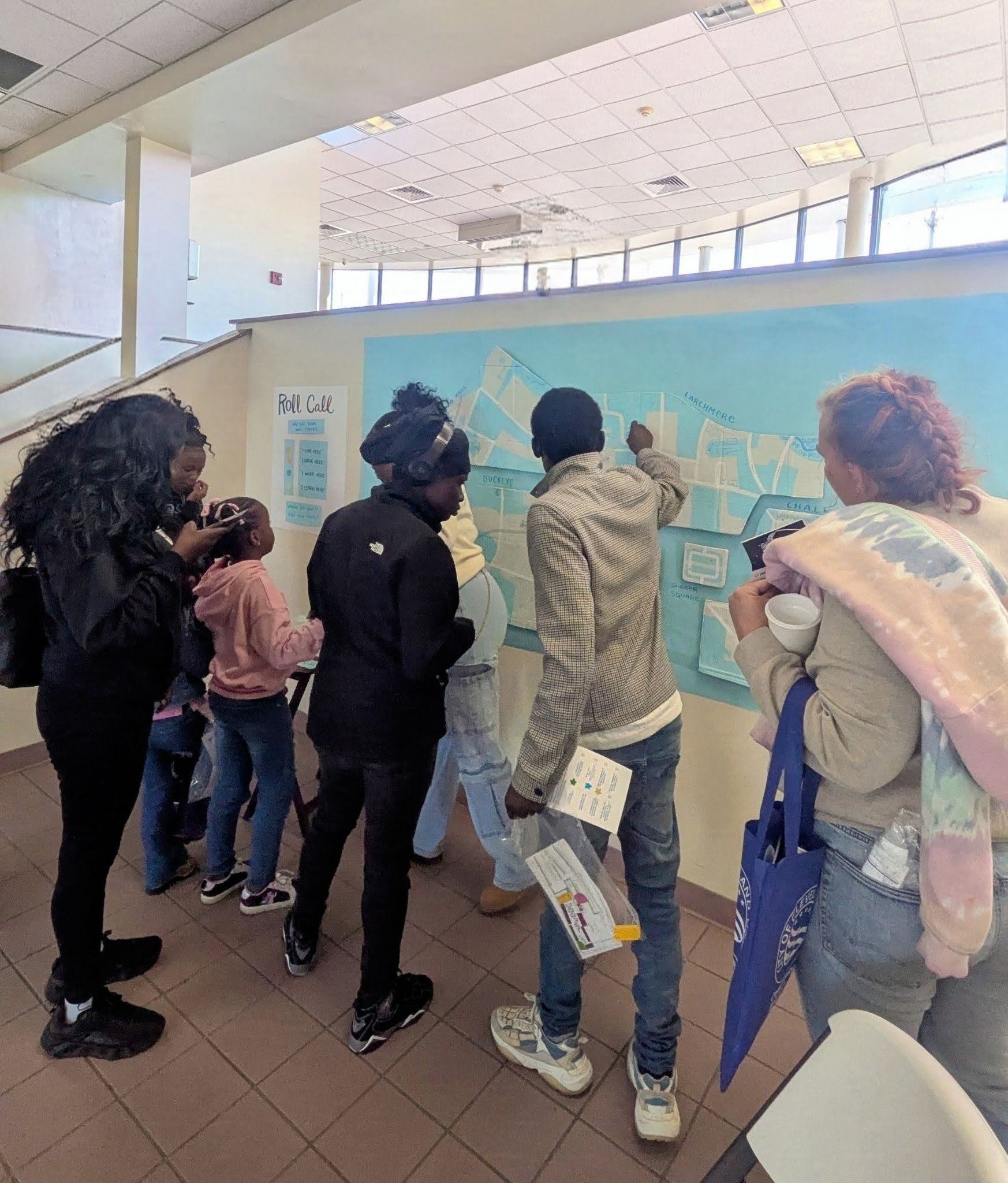 Festival participants studying a map on a wall at the learning space.