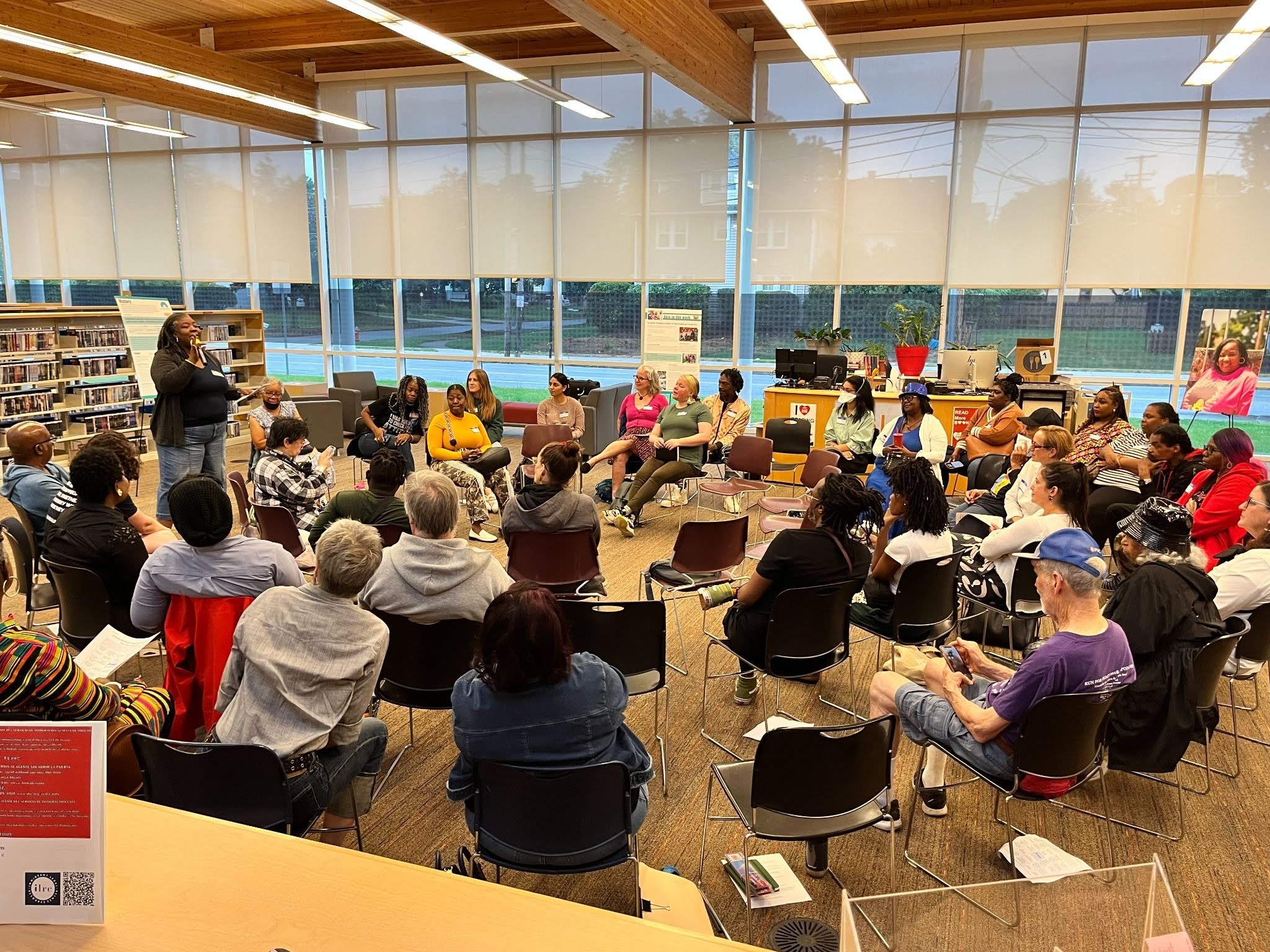 Community members seated in a circle in a library during a Neighbor Night
