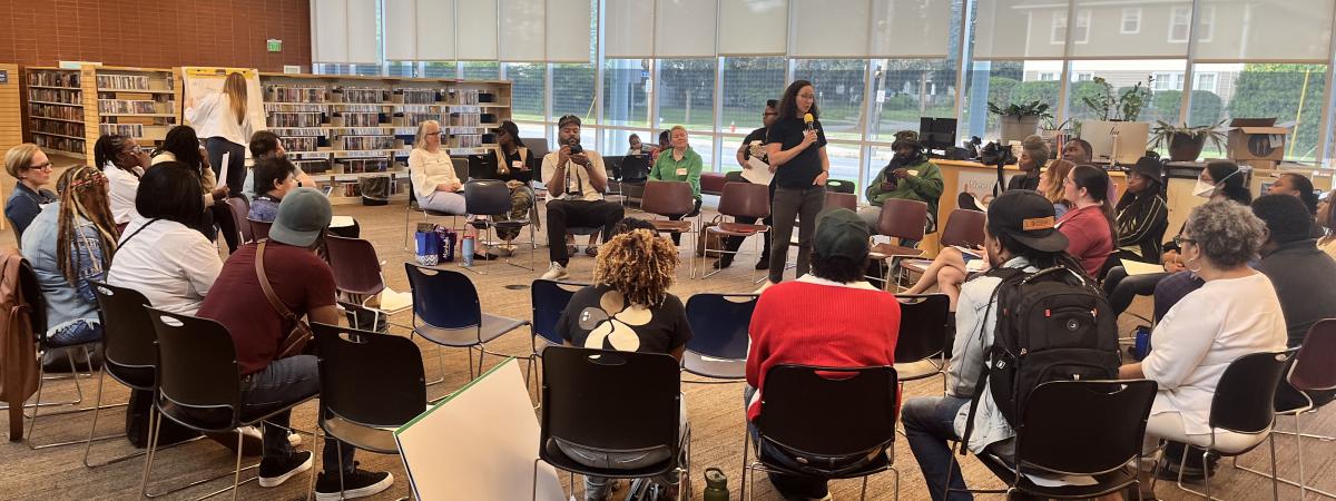 group of people sitting in a large circle