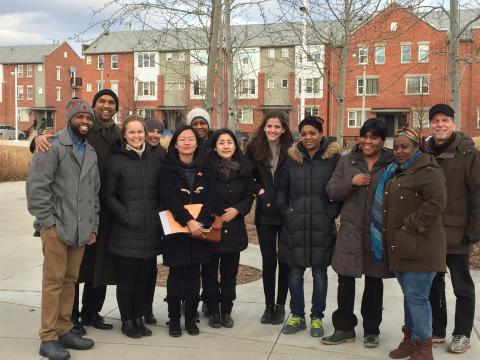 group of people standing outside posing for camera