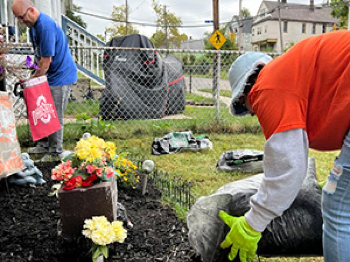 People outside planting flowers