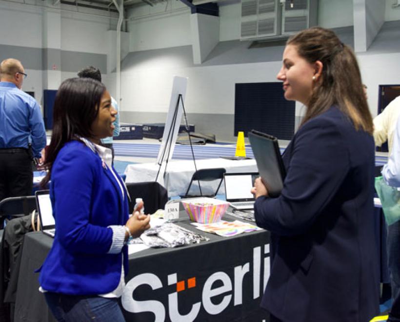 Student talking to a hiring manager at a career fair