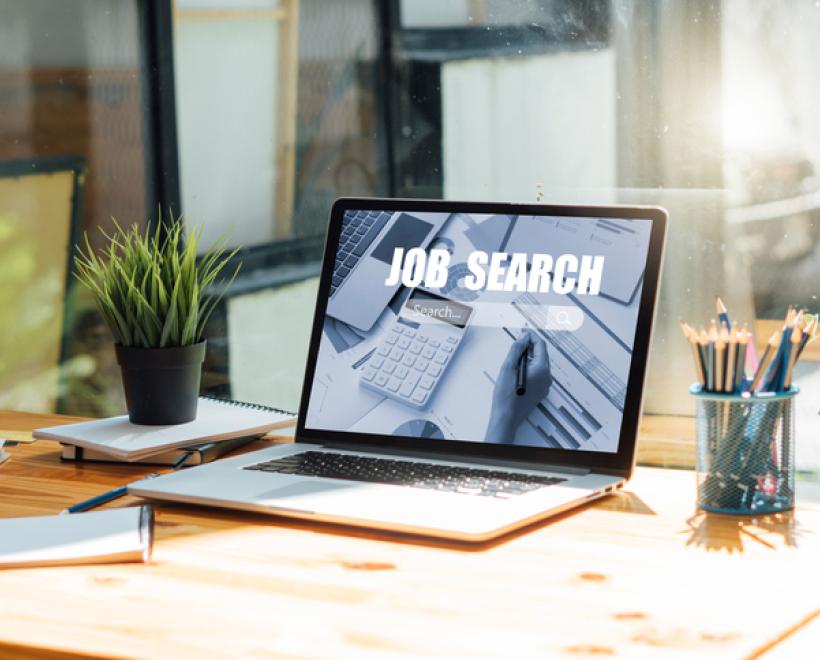 Open laptop on a desk with "Job Fair" on it