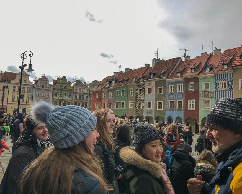 Study abroad group in front of old buildings in Poland