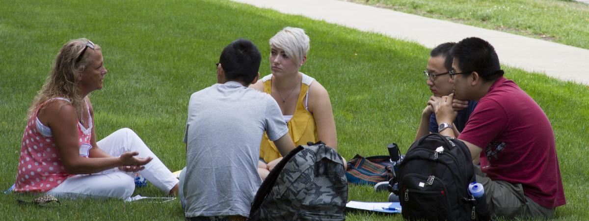 Student sitting and talking in grass