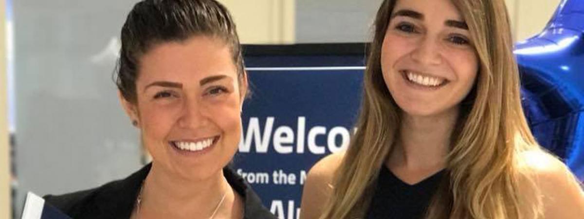 two woman holding banners that read Case Western Reserve University, think beyond the possible"