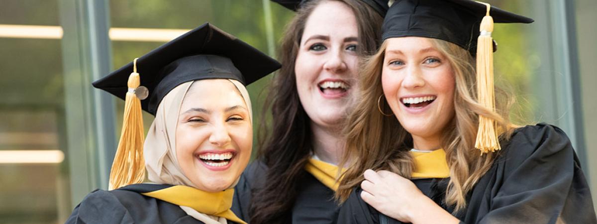 Three woman in graduation outfits